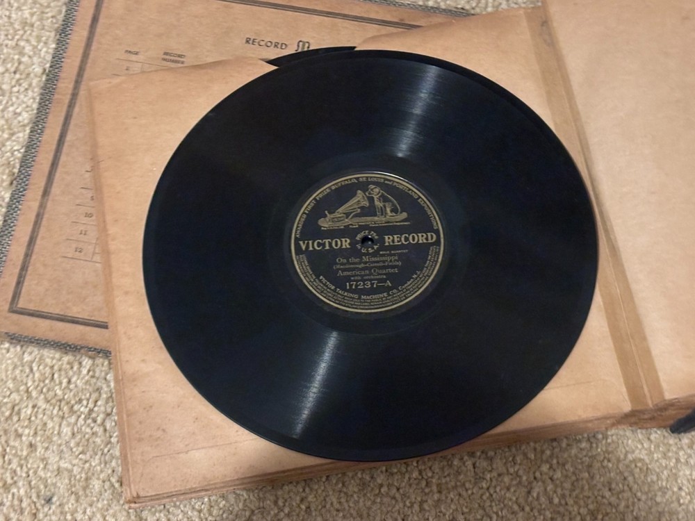 Lot of Nine (9) 78 rpm records in beautiful condition, in a book see list